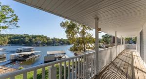 a balcony of a house with a view of a river at Lakefront 4BDBunkRm-25BA-DockFirepitSlide-14 in Sunrise Beach
