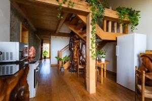 a living room with wooden ceilings and a spiral staircase at Séjour paisible près de Genève in Neydens