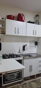 Køkken eller tekøkken på Kitnet compacta e acolhedora + 12 billeder