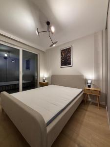 Postel nebo postele na pokoji v ubytování Eden Apartment