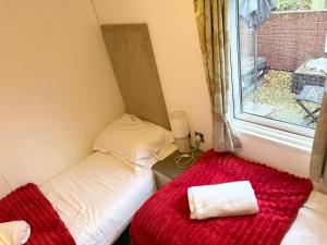 a small room with a bed and a window at Chloe Cabin in West Thirston