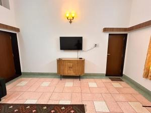 a room with a flat screen tv on a wall at Narpati Villa in Jodhpur
