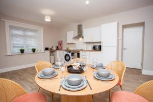 a dining room with a wooden table and chairs at Vacant Nests The Allendale Central 3BR in Allendale Town
