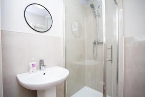a bathroom with a sink and a shower with a mirror at Vacant Nests The Allendale Central 3BR in Allendale Town +37 photos