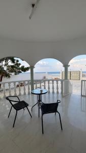 a patio with a table and chairs and a view of the ocean at Qantab village room in Muscat +45 photos