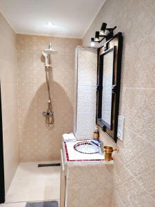 een badkamer met een wastafel en een spiegel bij Riad Darnooz Marrakech in Marrakesh