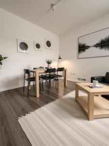 ein Wohnzimmer mit Tisch und Stühlen in der Unterkunft Apartment 3 Sea Centrum Stavanger in Stavanger