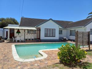 ein Haus mit einem Swimmingpool vor dem Haus in der Unterkunft Cozy Cove in Cape Town