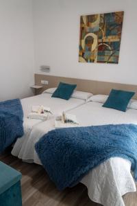 En eller flere senge i et værelse på Tres Torres Apartamento Turístico