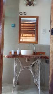 a bathroom with a sink and a mirror at La tinyhouse del bosque in Mar Azul