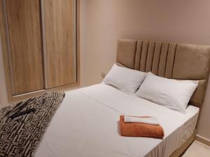 a bedroom with a large white bed with white pillows at Les belles loges in Bouskoura