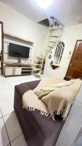 a bedroom with a large bed and a tv at Descanso e aconchego in Aparecida