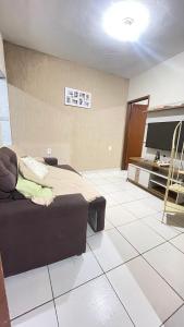 a room with a bed and a tv in it at Descanso e aconchego in Aparecida +9 photos