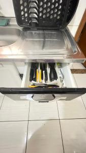 a drawer filled with lots of tools on a shelf at Descanso e aconchego in Aparecida