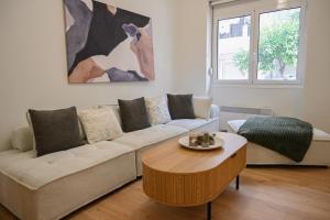 a living room with a couch and a coffee table at Portside Residence Piräus in Piraeus
