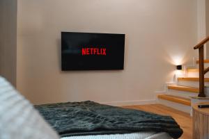 a living room with a tv on the wall at Portside Residence Piräus in Piraeus