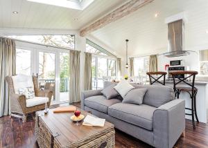 a living room with a couch and a table at Woodside Bay Lodge Retreat in Wootton Bridge
