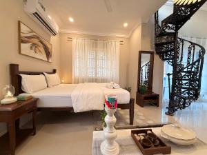 a bedroom with a large bed and a staircase at Villa Marina -By The Beach Goa in Benaulim +157 photos