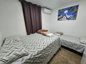 En eller flere senge i et værelse på Q 163 Apartamento TÉRREO completamente mobiliado, 02 quartos