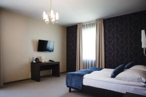 Posteľ alebo postele v izbe v ubytovaní Hotel Cztery Pory Roku