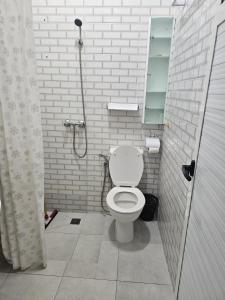 a white bathroom with a toilet and a shower at Marrakech héberg in Marrakesh +22 photos