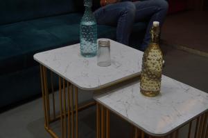 a couple of tables with vases on top of them at Yatindra Ashraya in Etāwah