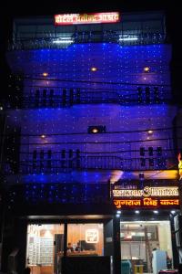 a building with blue lights on the side of it at Yatindra Ashraya in Etāwah