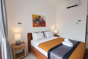 Postel nebo postele na pokoji v ubytování Summer of Surf Canggu + 23 fotografií