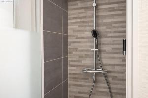 a shower in a bathroom with a glass door at Le Retro Gaming - Le Havre Train Station in Le Havre