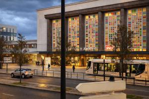 a bus is parked in front of a building at Le Retro Gaming - Le Havre Train Station in Le Havre