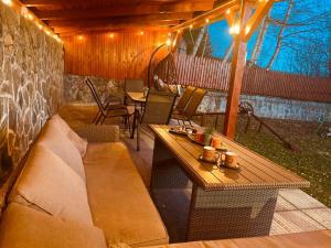 a patio with a couch and a table and chairs at Cavljak Retreat, Sarajevo in Barice