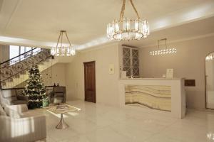 a living room with a staircase and a christmas tree at Phazisi Hotel in Tbilisi City