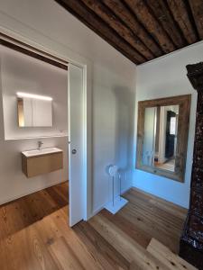 a bathroom with a sink and a mirror at NEW Locanda da Raimondo - das Knarren der Zeit in Tarvisio +135 photos