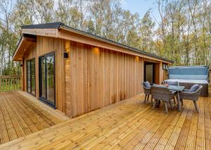 una casa con terrazza e vasca idromassaggio di Elton Furze Retreats a Haddon