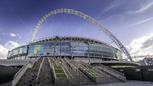 a large building with stairs in front of a stadium at Studio flat close to Heathrew Airport in Northolt