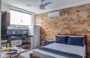 a room with a bed and a brick wall at APART STUDIOS PONTAL in Ilhéus +58 photos