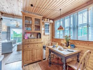 a kitchen with a table and chairs in a room at Hygge Cabin in Hexham