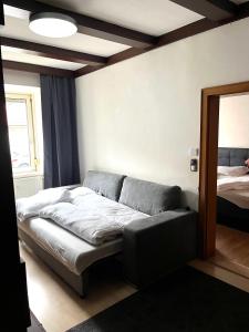 a bed in a room with a mirror at Stadtwohnung Bruck an der Mur in Bruck an der Mur