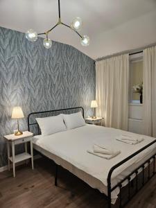 a bedroom with a large bed with two night stands at Mountain View Amza Accomodation in Râşnov