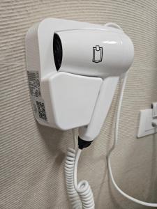 a white phone is plugged into a wall at Mountain View Amza Accomodation in Râşnov