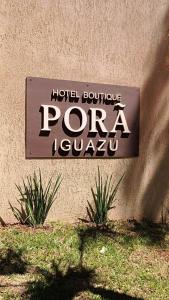 a sign on the side of a building at Hotel Boutique Porá Iguazú in Puerto Iguazú