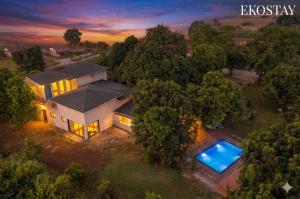 an overhead view of a house with a swimming pool at EKOSTAY - Brick Wood in Karjat