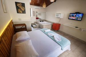 Giường trong phòng chung tại Pousada Charmosa Lua Nova Pipa