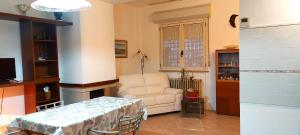 a living room with a table and a chair at Hotel Cadiz in Rimini