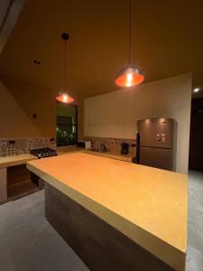 een keuken met een aanrecht en een koelkast bij Casa Colibrí in Zipolite