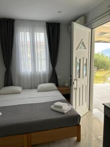 una camera da letto con un letto e una porta scorrevole in vetro di Villa Amantia a Kouvaláta Altre 57 foto