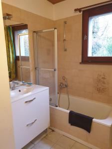 a bathroom with a shower and a sink and a tub at Logement du Bois de Chaubon in Fillinges +12 photos