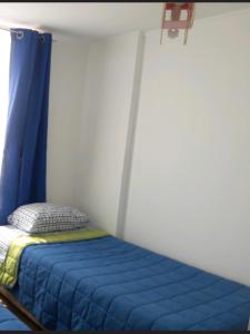 En eller flere senge i et værelse på Departamento Amoblado