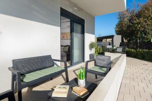 twee stoelen en een tafel op een patio bij Aegean Escape Luxury Apartment in Rhodos-stad