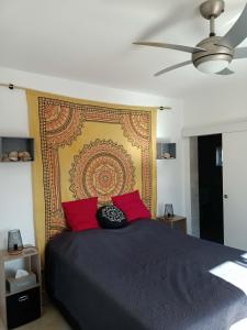 a bedroom with a large bed with red pillows at B&B Casa Flamenga in Alte +44 photos